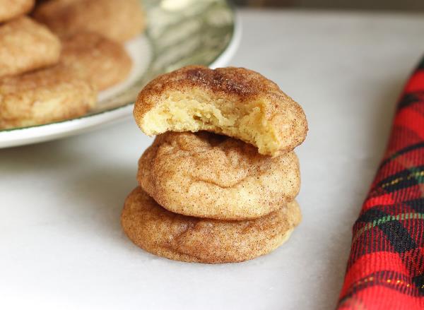 snickerdoodle coo<em></em>kies in a pile with a bite in one coo<em></em>kie